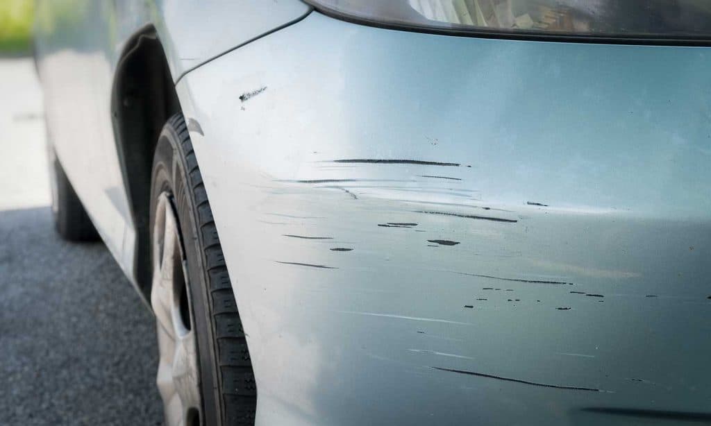 Scratched car with deep damage to the paint