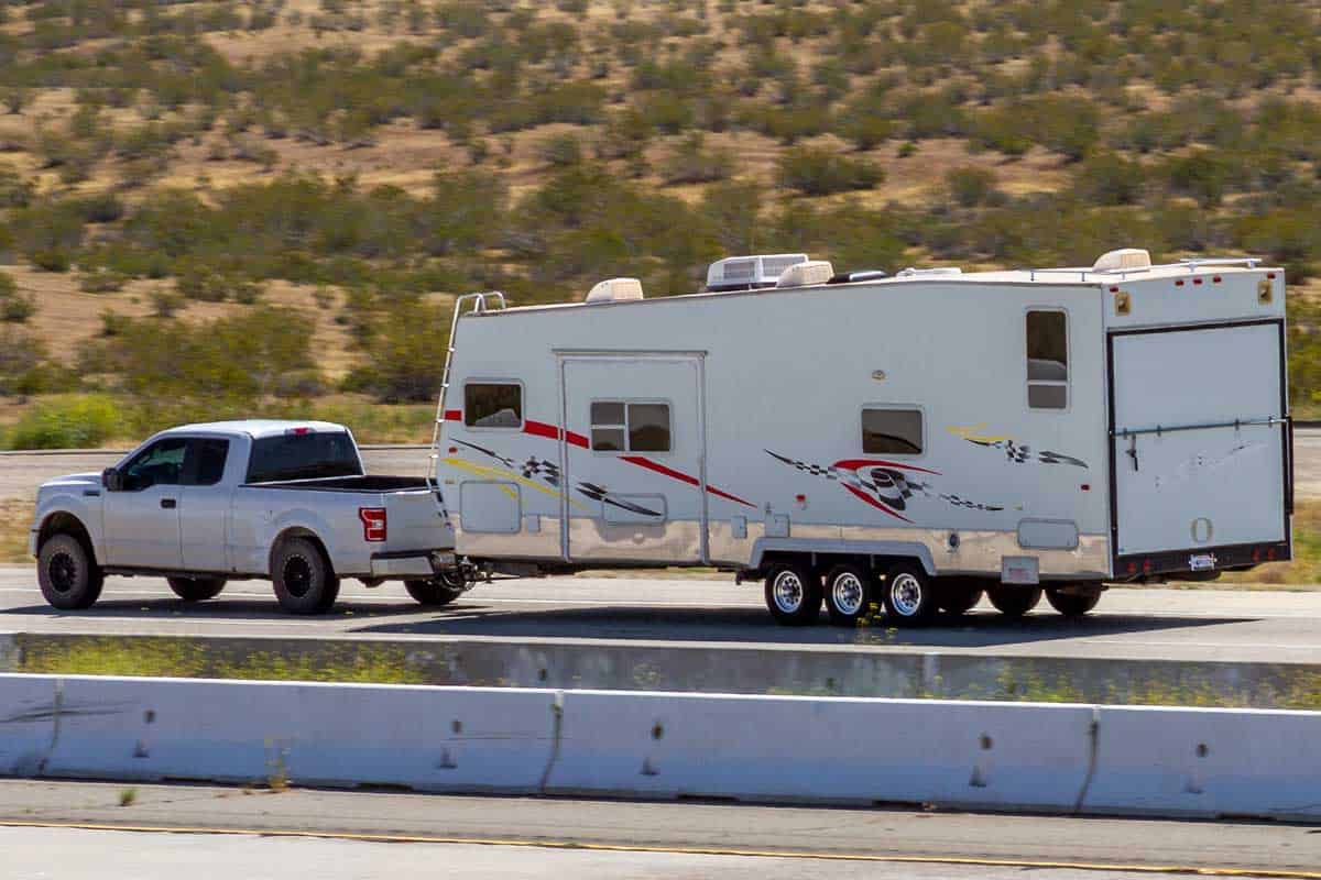 Truck towing a RV trailer, 6 Small And Lightweight Toy Hauler RVs Under 5,000 Lbs