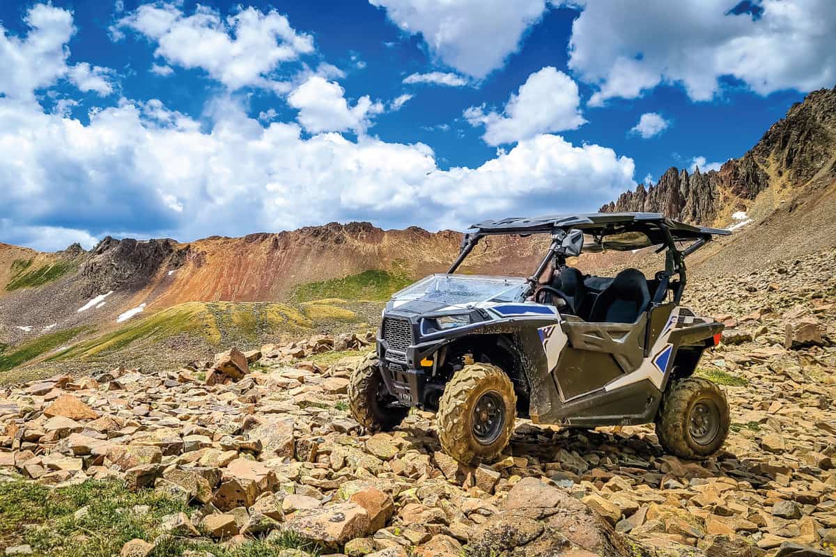 4x4 Side-by-Side off-road vehicle, UTV ATV with a beautiful mountain range in the background 