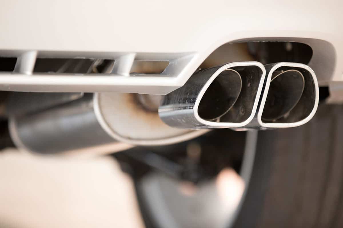 A dual exhaust pipe of a car, How To Reduce Exhaust Noise Inside Car