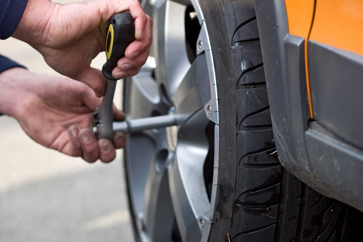 A man changing wheel of a car, Should You Rotate Tires On AWD And 4WD Vehicles?