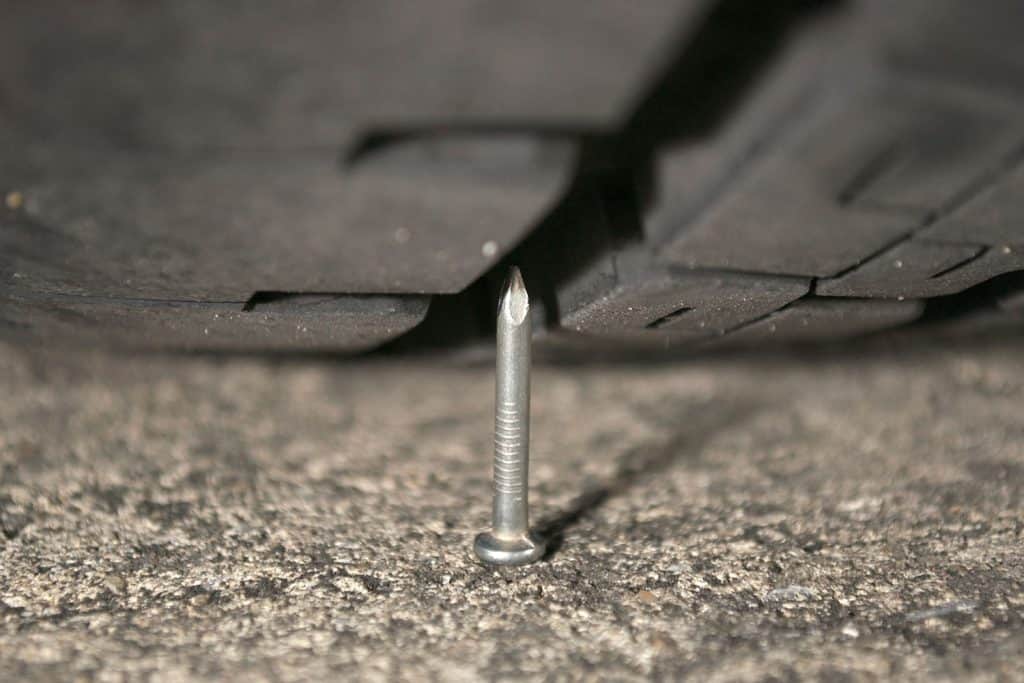 A nail poiinted upwards to the truck tire
