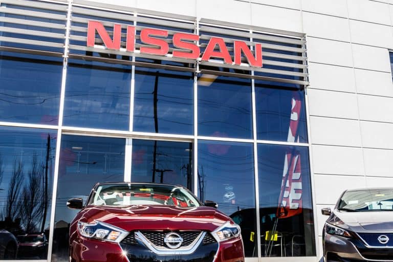 A red Nissan Altima parked outside a Nissan dealership, Does The Nissan Altima Have AWD Or 4WD?