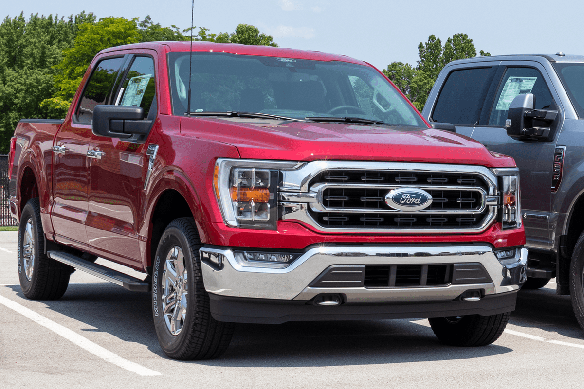 A red colored Ford F-150 at a parking lot