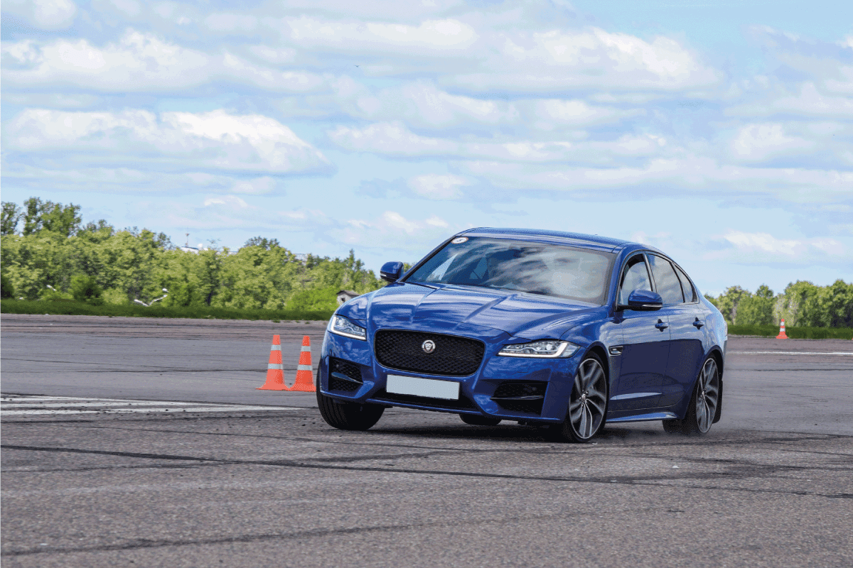 Blue-Jaguar-XF-sedan-drives-on-a-handling-track-during-test-drives.-Does-The-Jaguar-XF-Have-A-Spare-Wheel