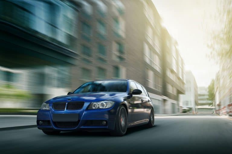 Blue car BMW 5 series E90/E91 Fast speed drive on city road, How Many Miles Does A BMW Last? [Breakdown By Model]