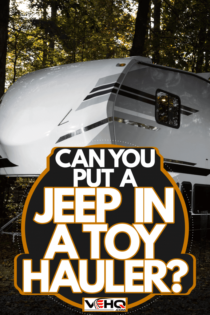 A huge white camper trailer in the forested area, Can You Put A Jeep In A Toy Hauler?