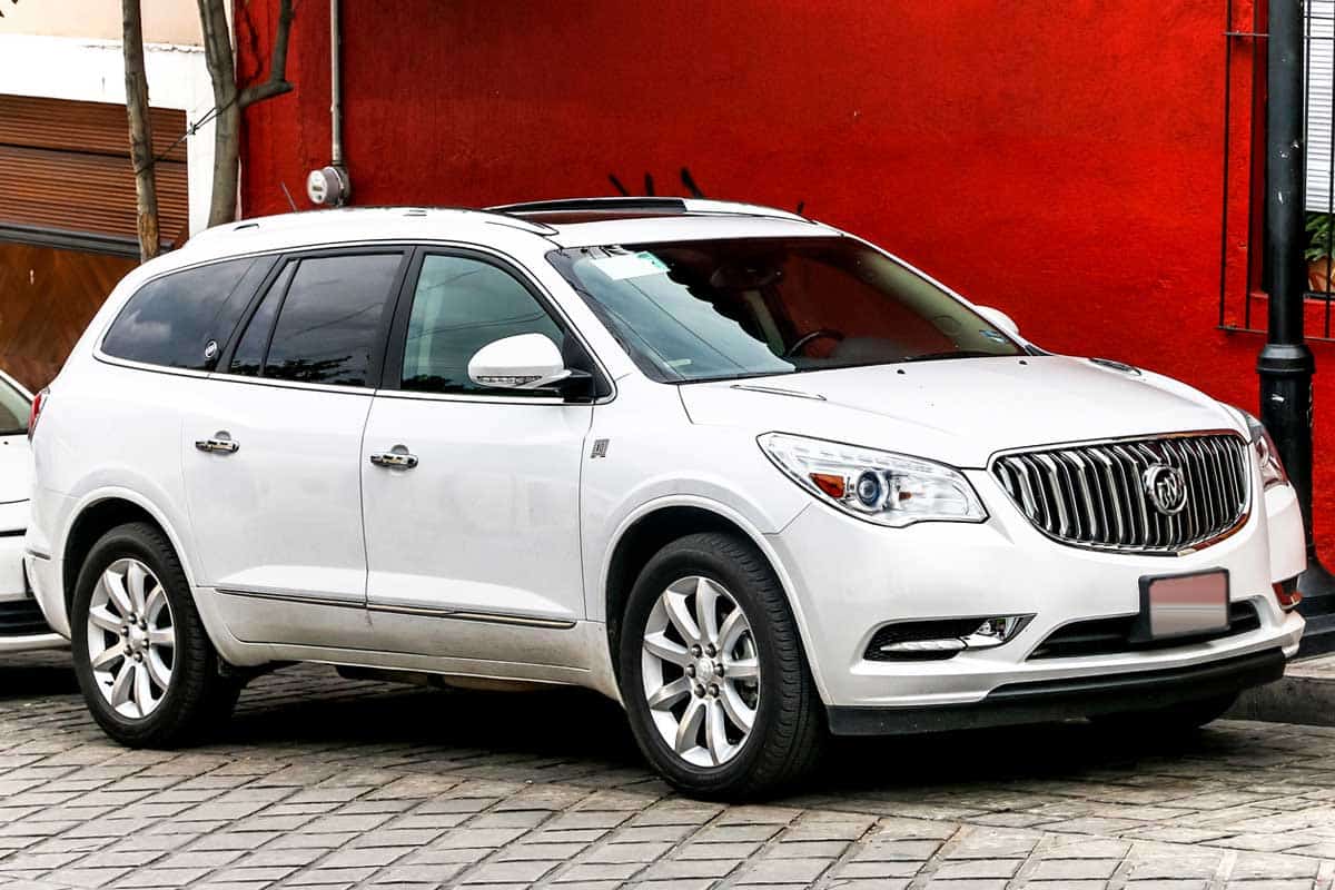 Car Buick Enclave in the city street, Does The Buick Enclave Have 3 Rows?