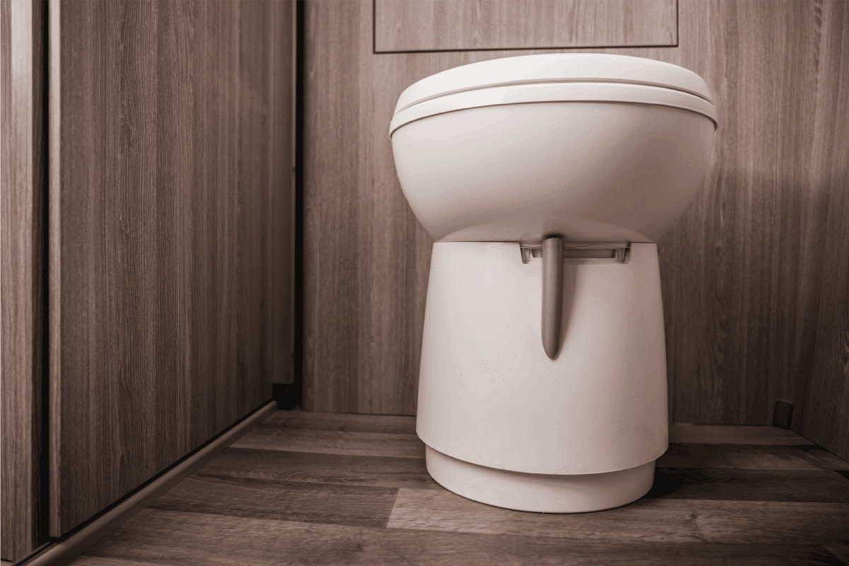 Close-Up-Of-White-Toilet-In-Tan-Small-Area-Of-Recreational-Vehicle-Restroom-Cabin