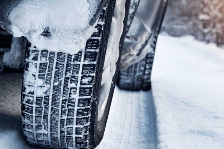 Close up of car tires in winter on the road covered with snow, Do Tires Expand Or Shrink In The Cold?