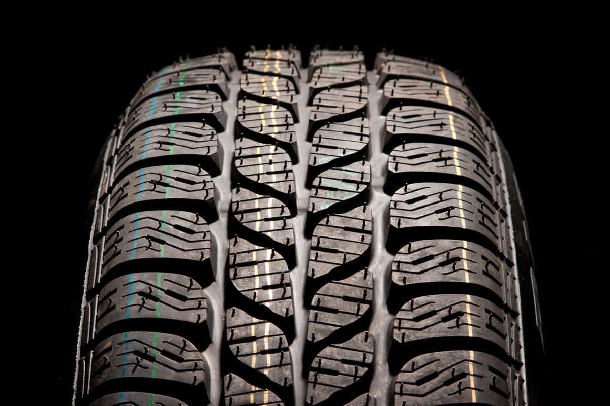 Detailed car tire treads on a black background, Do Tires On A New Car Typically Have A Warranty?