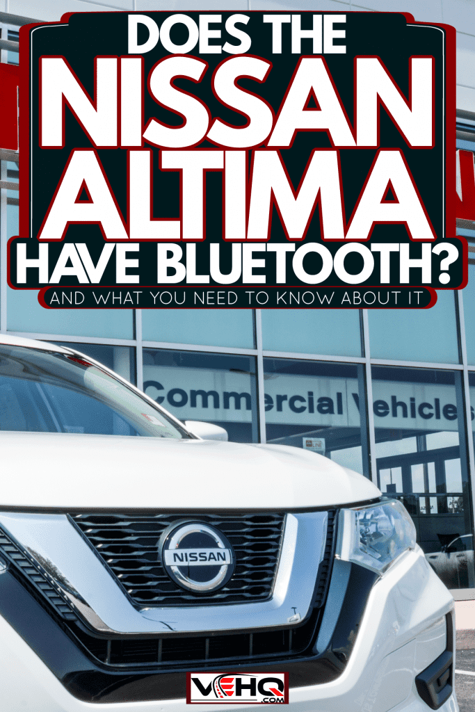 A Nissan Altima parked outside a Nissan dealership, Does The Nissan Altima Have Bluetooth? [And What You Need To Know About It]