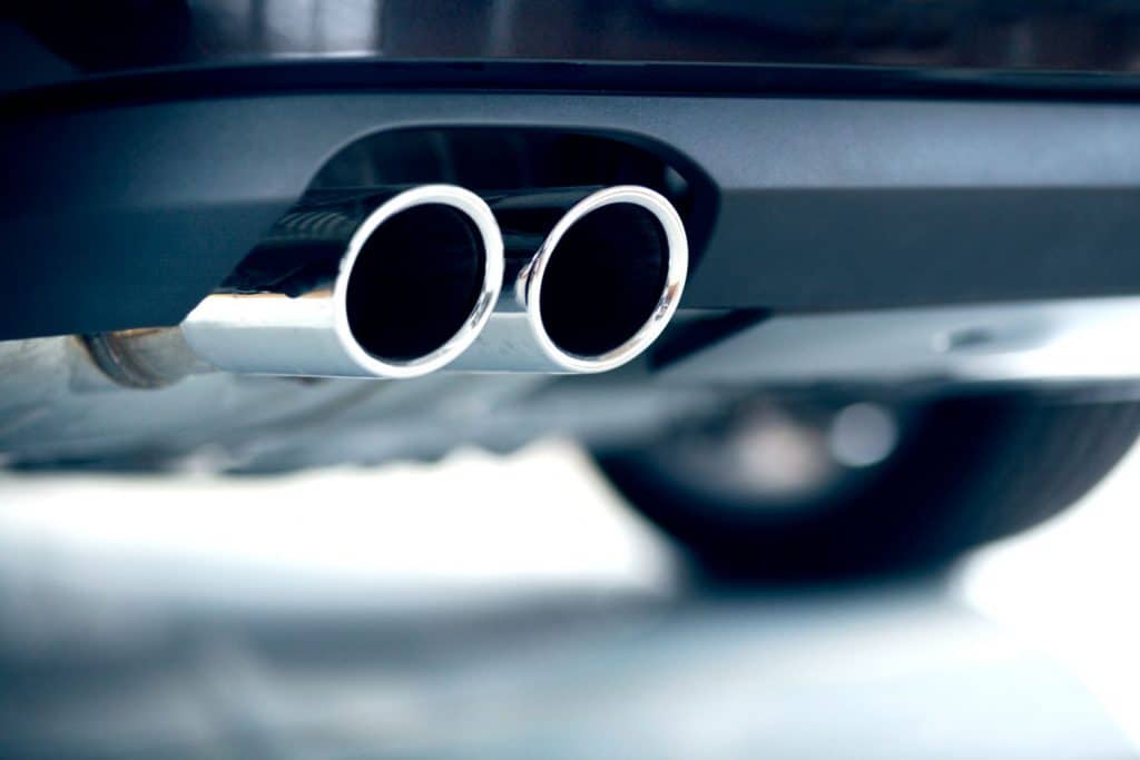 Dual stainless steel exhaust of a car photographed on selective focus