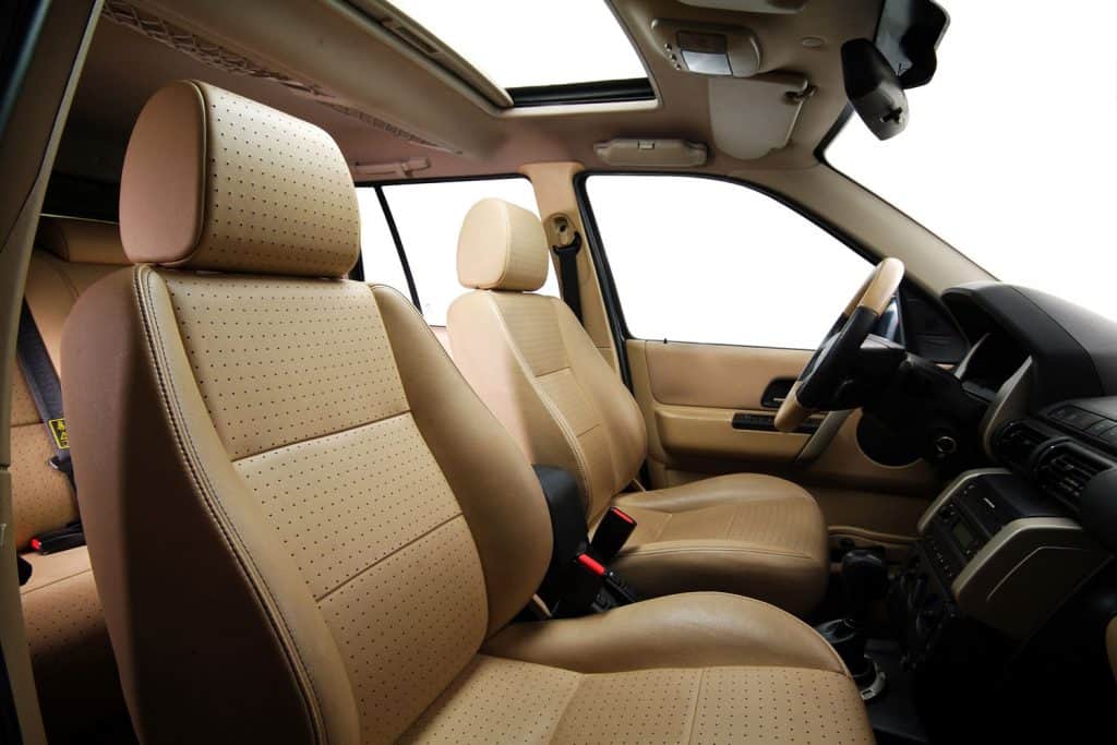 Interior of a luxurious car with leather car seats and gorgeous lining on the dashboard