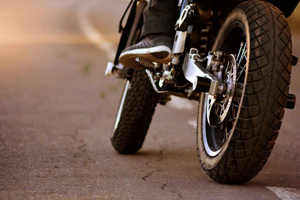 Motorcycle with biker on the asphalt road