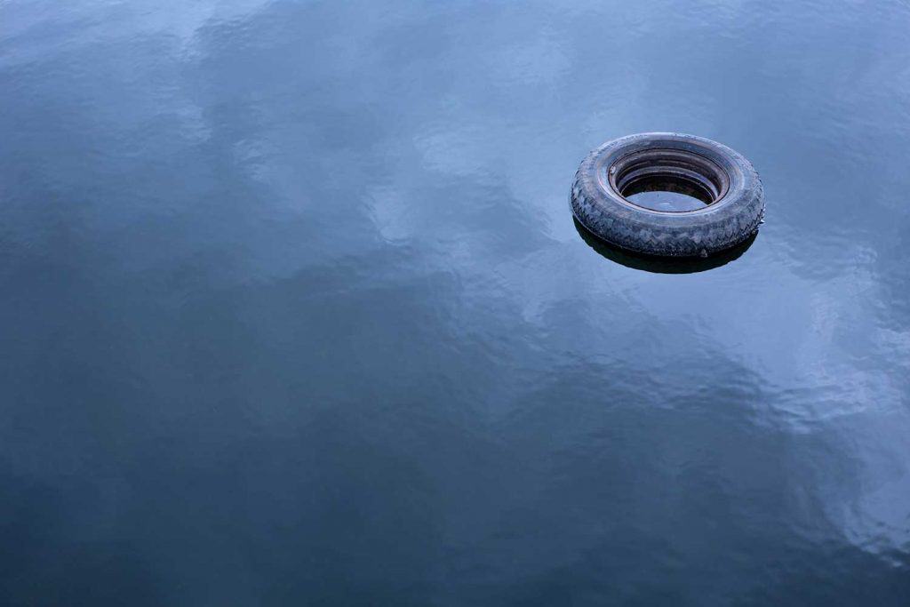 Old tire floating in water