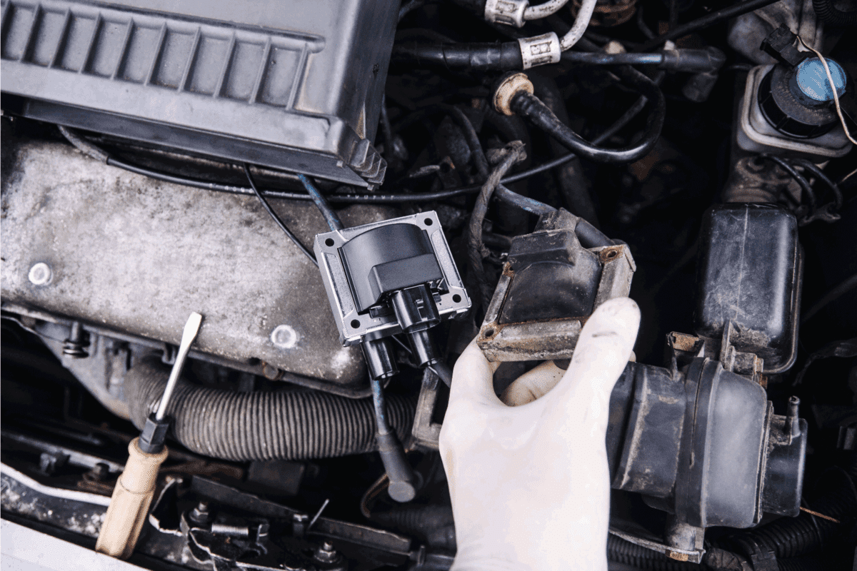 Repair electricians ignition coils in a car, high-voltage wires.