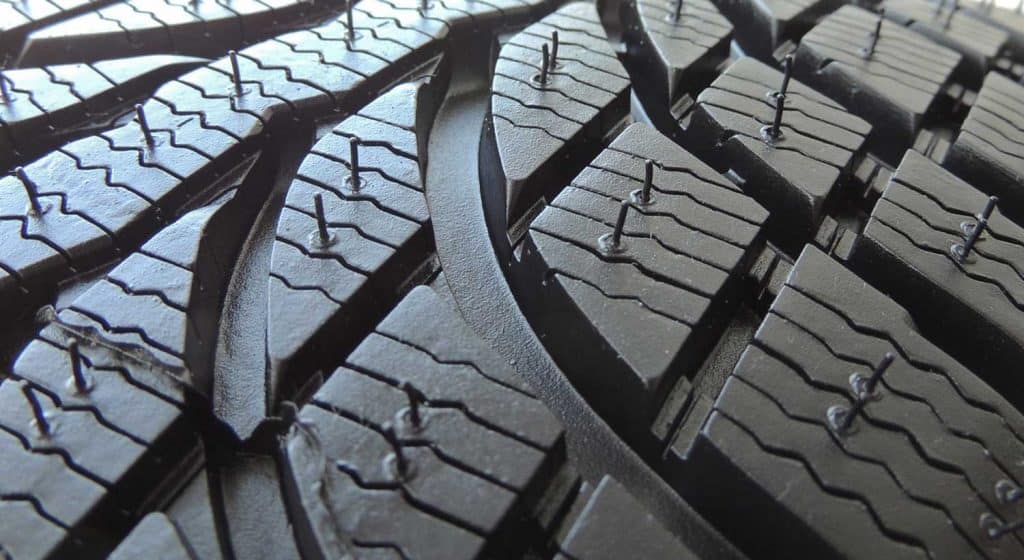 Rubber surface of new car tire with sipes and grooves