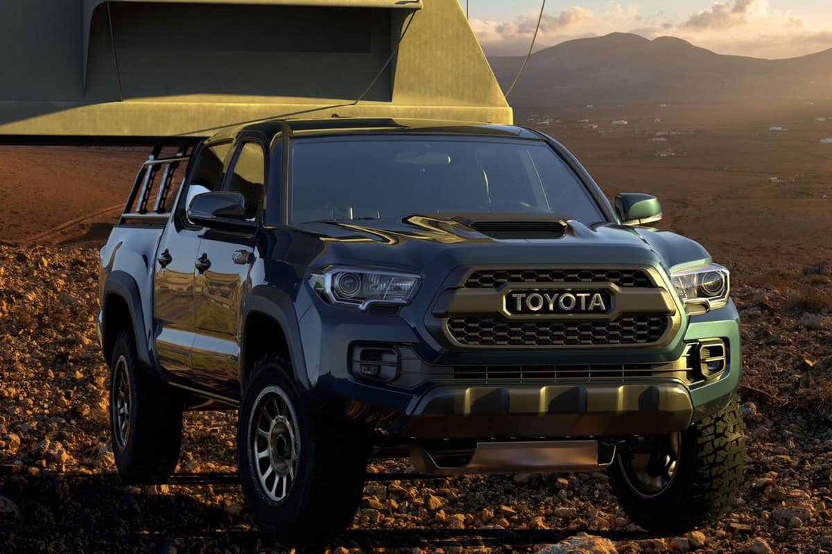 Toyota Tacoma equipped with a camping tent in mountainous terrain, Toyota Tacoma SR5 Vs. TRD - What Are The Differences?