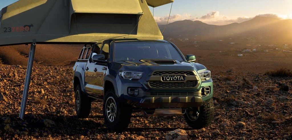 Toyota Tacoma equipped with a camping tent in mountainous terrain