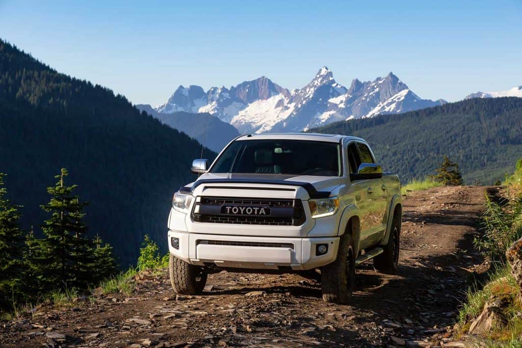 Toyota Tacoma riding on the 4x4 Offroad Trails in the mountains during a sunny summer morning