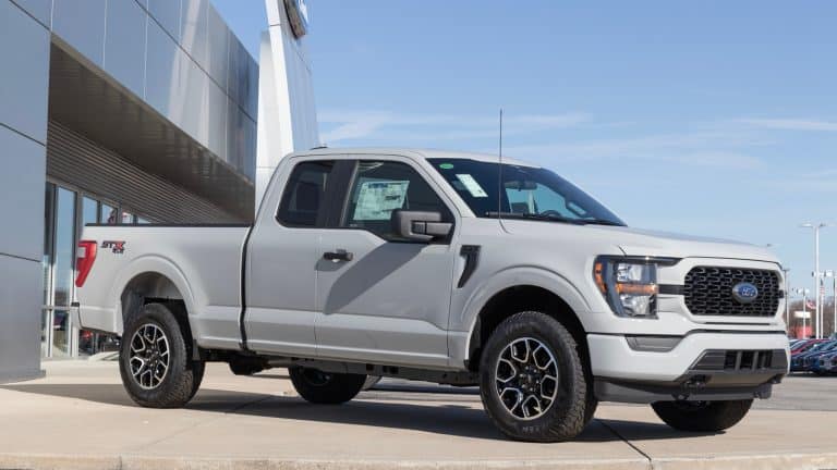 White Ford F-150 display at a Ford dealership 1600x900
