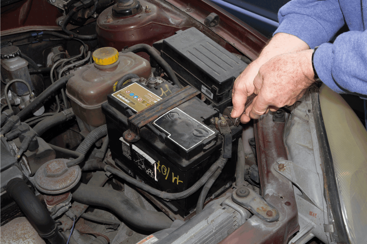 car mechanic installing car battery again