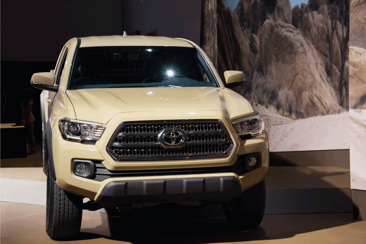 khaki Toyota Tundra on display at an international motor show. Can You Flat Tow A Toyota Tundra Behind A Motorhome