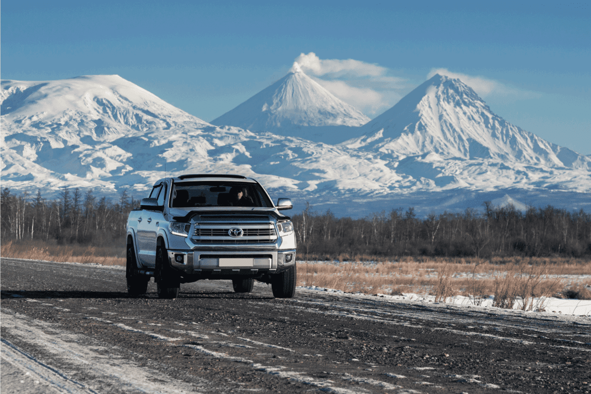 toyota tundra driving on a gravel road with winter background