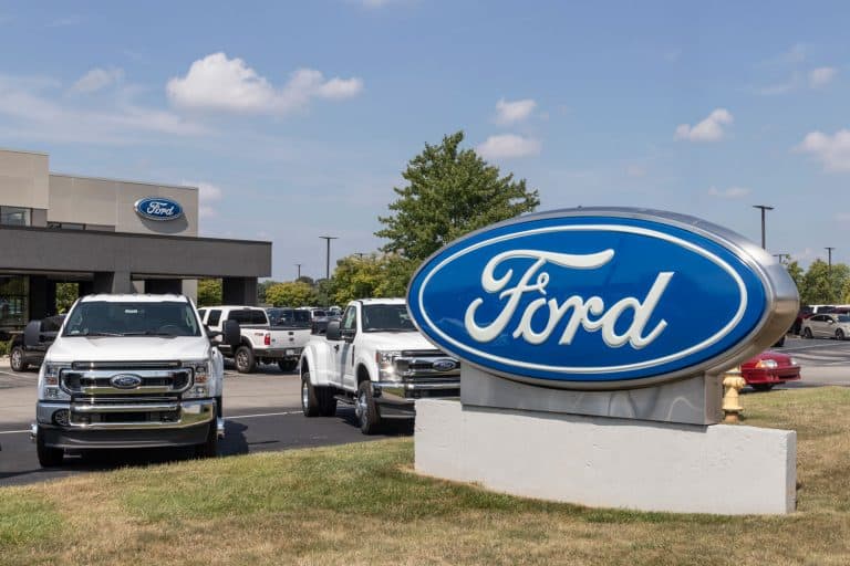 A Ford factory with Ford F-series trucks displayed on the back, What Is The Ford Factory Order Process?