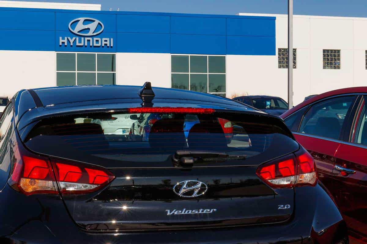 A Hyundai Veloster outside Hyundai motor company dealership