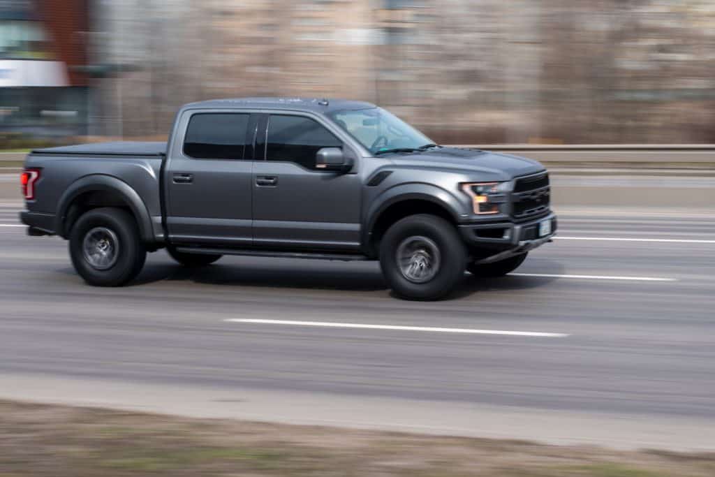 A dark gray colored Ford F-150 photographed while running in the highway