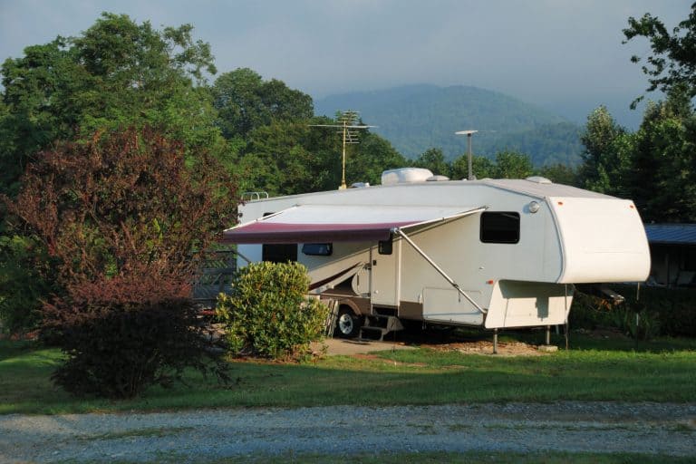 A fifth wheel photographed on the camping grounds parking lot, 5th Wheel to Gooseneck Adapter: Pros & Cons