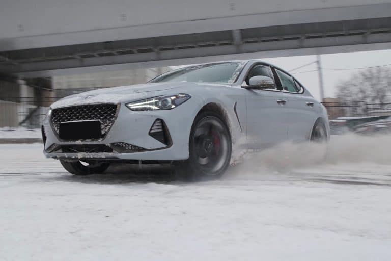 A gray Genesis G70 drifting on the snow, Does The Genesis G70 Require Premium Gas?
