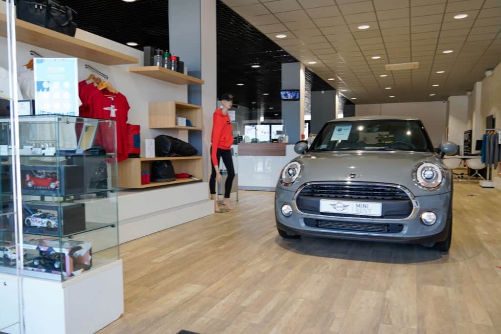 A gray colored Mini Clubman at a small dealership
