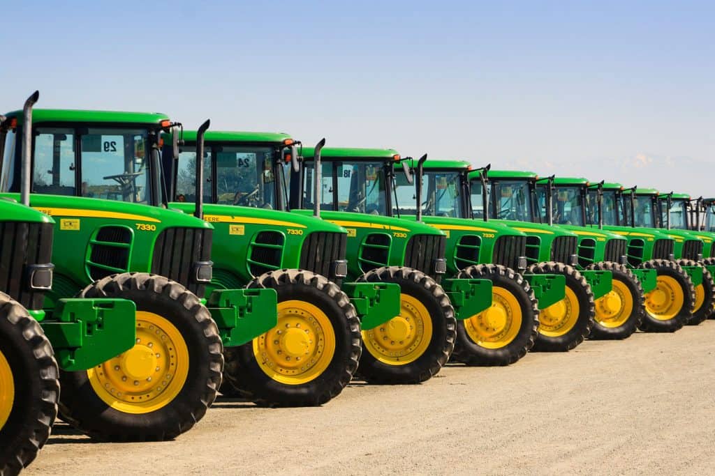 A line up of green John Deere tractors