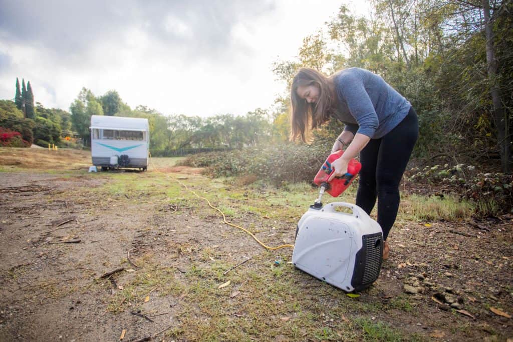 A woman refilling the RV generator with diesel fuel