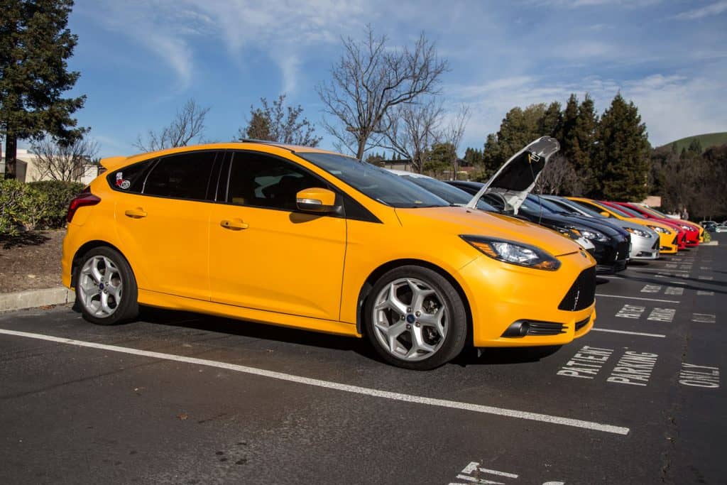 A yellow colored Ford Focus photographed at a parking lot