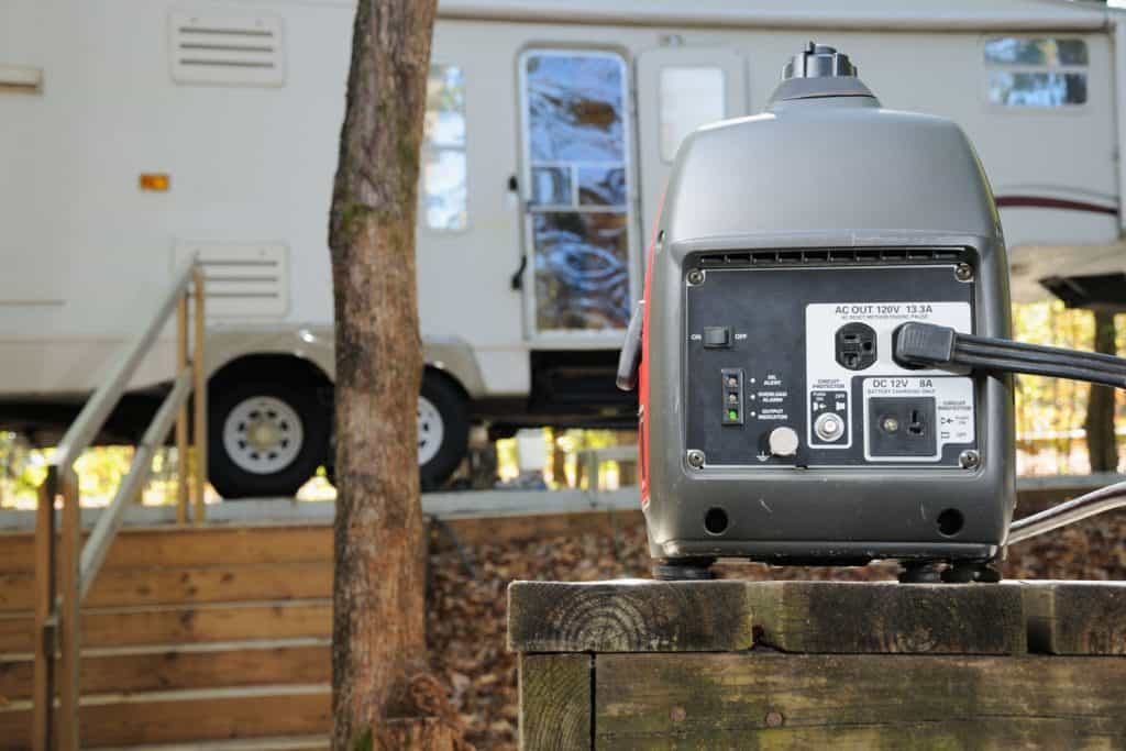 An isolated photo of an RV generator with an RV on the background