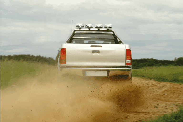 Back wiev of a pickup truck drifting on gravel road. How To Install Lights Under A Truck [11 Steps To Follow]