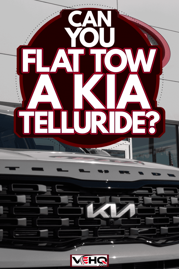 A white Kia Telluride parked outside a Kia dealership, Can You Flat Tow A Kia Telluride?