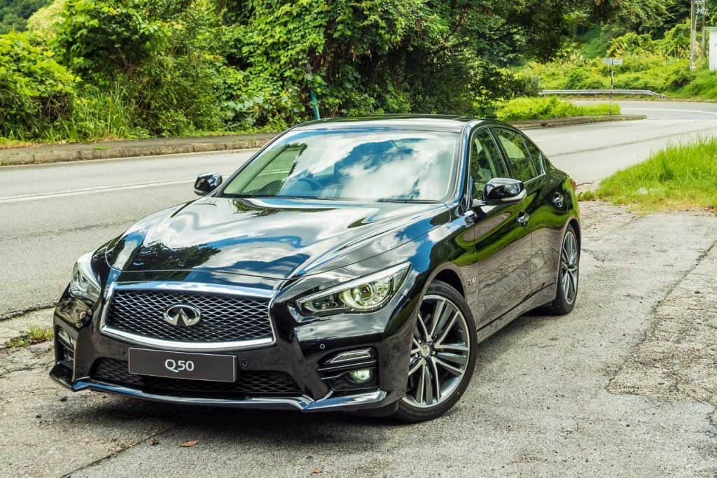 Infiniti Q50 S 3.0T Red Sport 400 parked on the side of the road