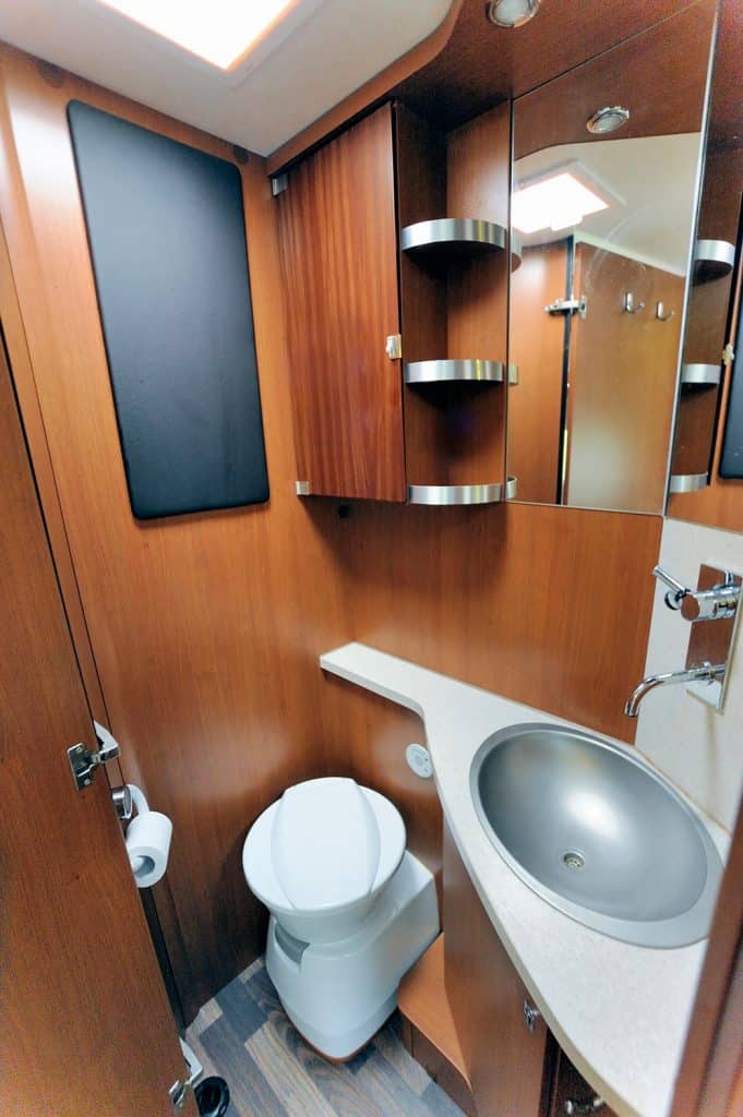Inside of RV with washroom toilet sink shower cabinet