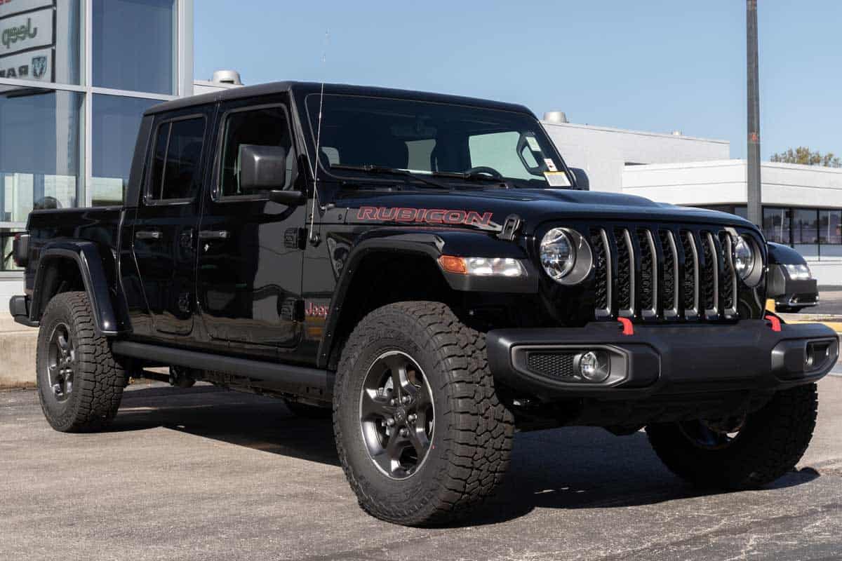 Jeep Gladiator display at a Jeep Ram dealer, Can You Fit 3 Car Seats In A Jeep Gladiator? [What You Need To Know!]