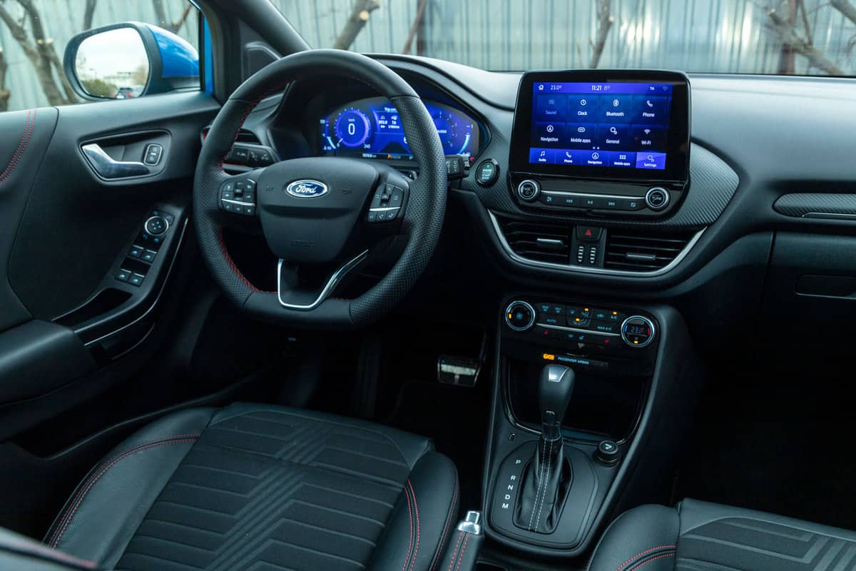 Leather stitching and high tech infotainment monitor on the dashboard of a Ford Puma