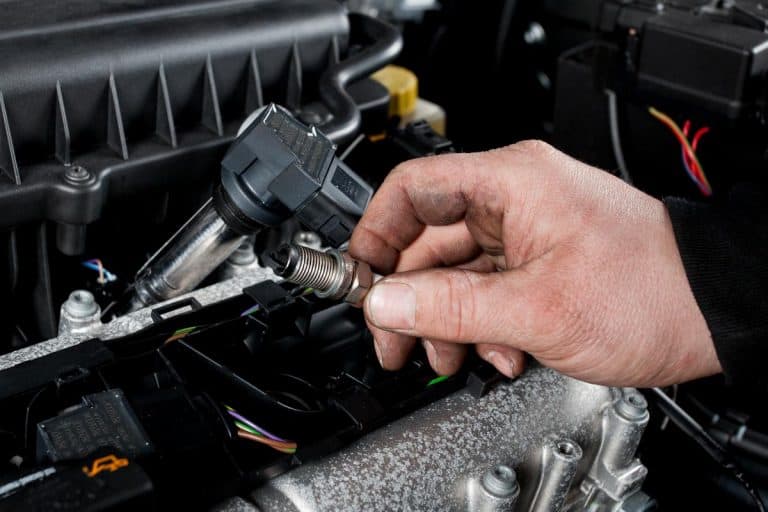 Mechanic checks the ignition plugs of a modern car, Do Modern Car Engines Have Spark Plugs?