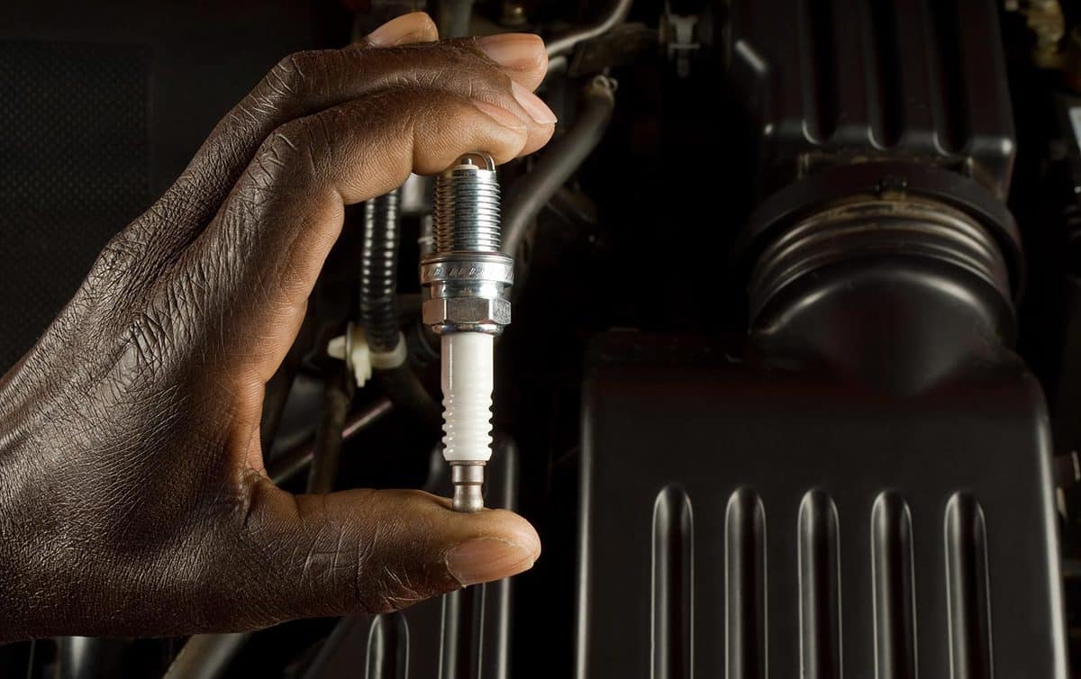Mechanic holding spark plug