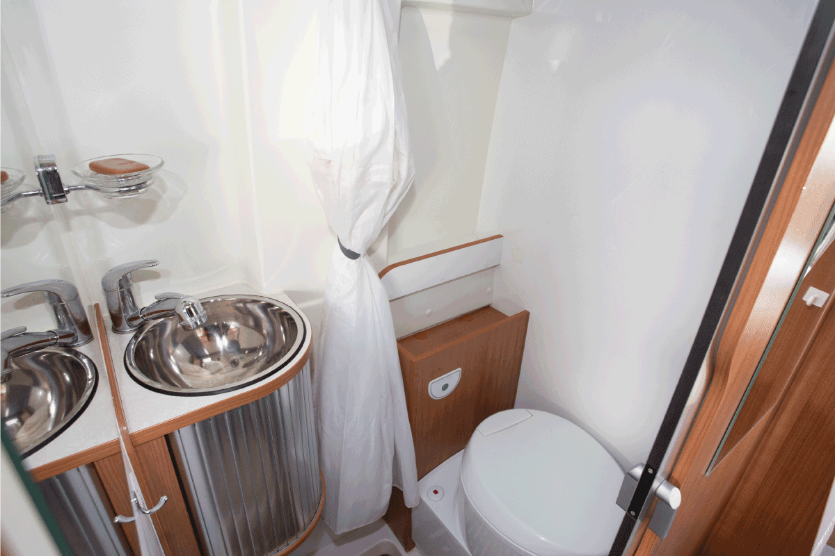Modern camper inside van interior of bathroom toilets in new motorhome. How Often To Use RV Toilet Chemicals
