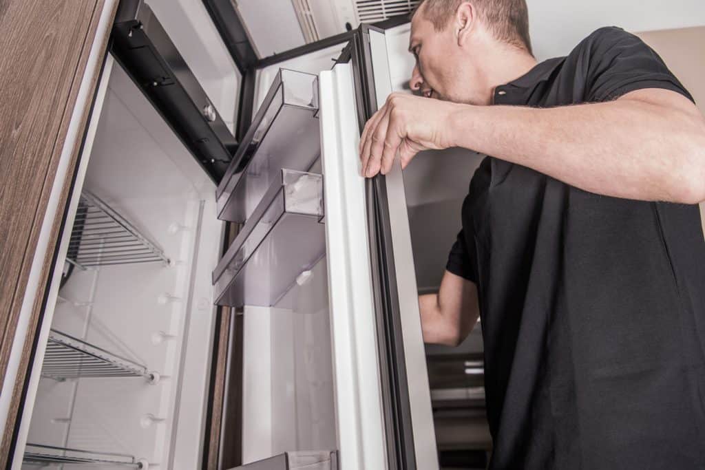 Refrigerator Replacing Inside Camper RV Motorhome by Caucasian Appliances Technician