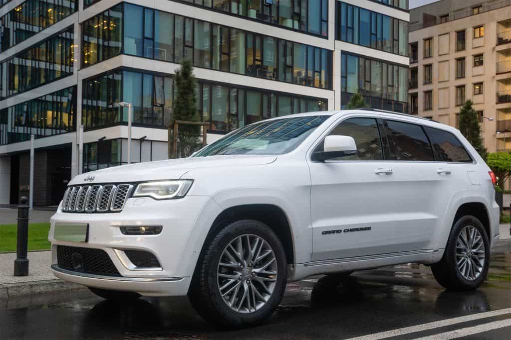 SUV Jeep Grand Cherokee model against the background of modern buildings